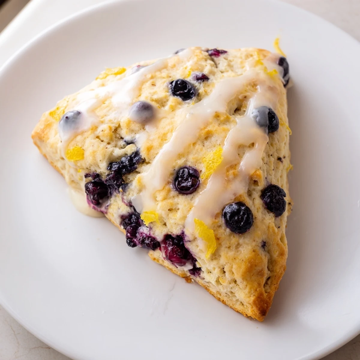 Enjoy these flavorful, homemade Lemon Blueberry Scones, perfect for a special brunch with friends.