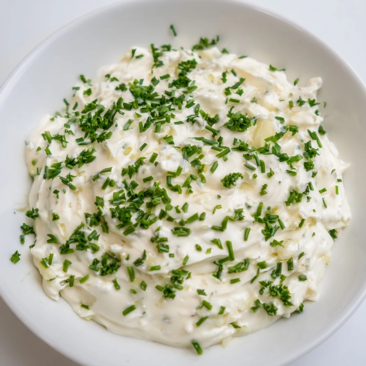 Fresh vibrant Garlic Dip served with crunchy carrot sticks, perfect for dipping and snacking.