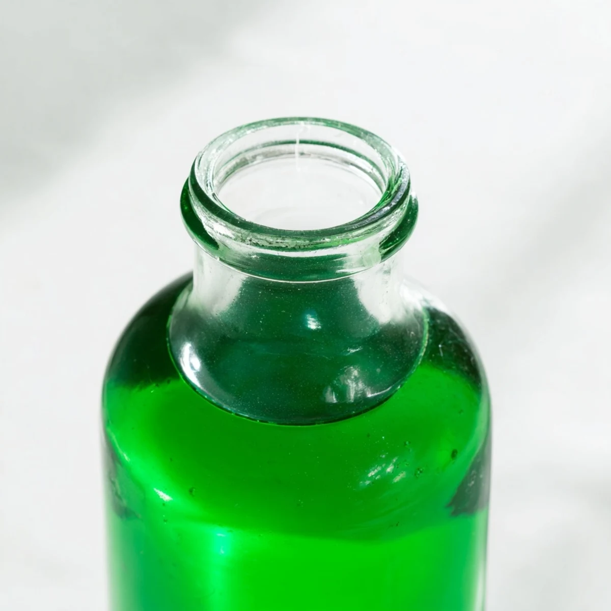 Homemade peppermint extract steeping in a glass jar, a key ingredient for holiday baking.