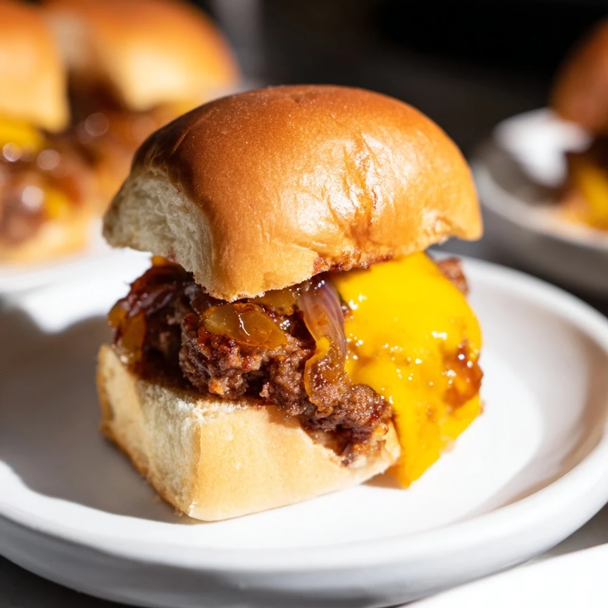 Golden-brown Beef Sliders with Caramelized Onions and melted cheese, ready to enjoy with friends.