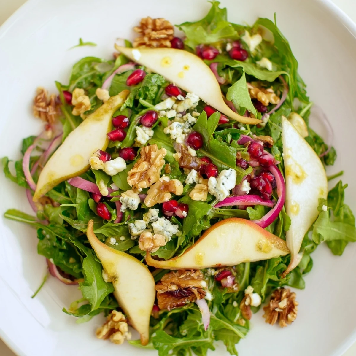 This Winter Green Salad features glistening pears and toasted walnuts with vibrant greens, ready to eat!