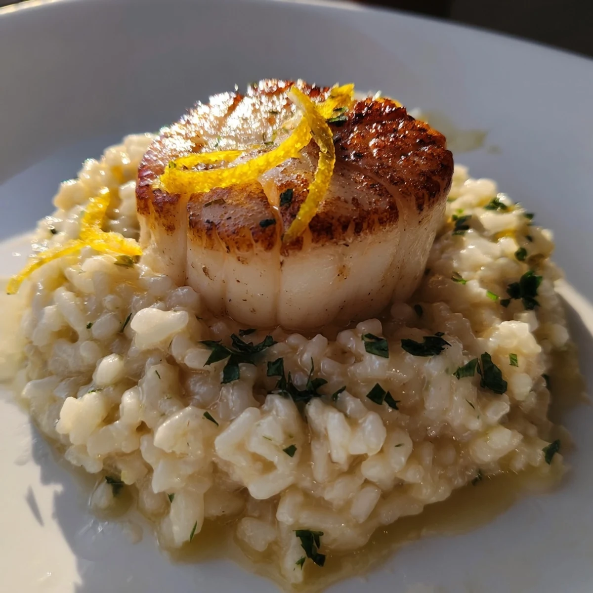 Close-up of Lemon Garlic Scallops with Risotto, highlighting the zesty butter sauce and perfectly cooked grains of Arborio rice.