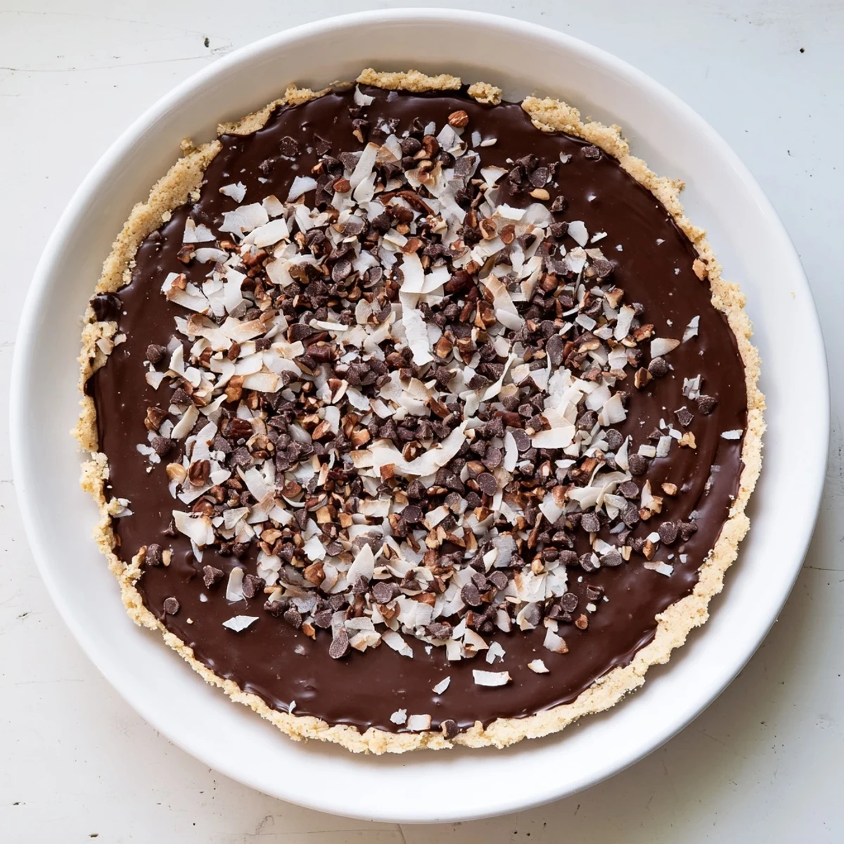 Golden-brown, chewy Chocolate Treat Bar Sweet squares topped with melted chocolate chips, chopped pecans, and sweet shredded coconut.