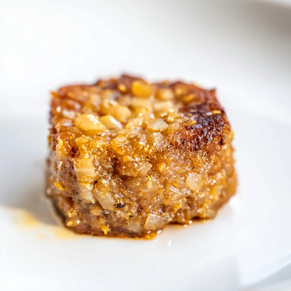 Rustic kitchen counter showing a pile of golden Beef Treat Bites Snack with a wooden spoon and ingredients nearby.