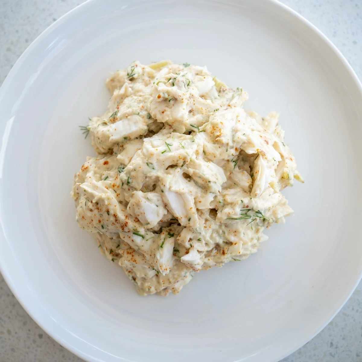 Cajun Remoulade Sauce with Crab, garnished with fresh parsley and celery, served chilled in a rustic bowl for dipping.