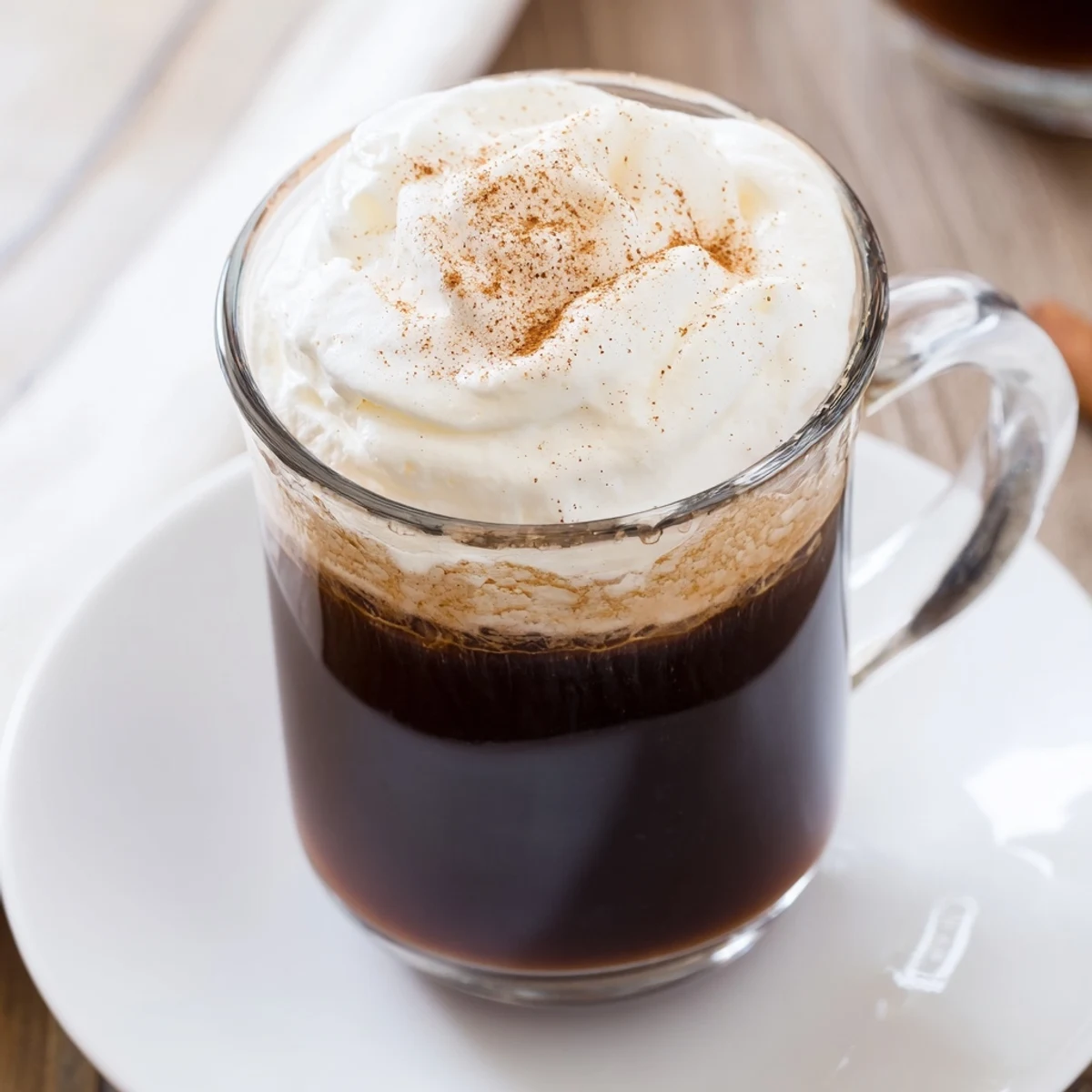 Close-up of a creamy Irish Coffee Mocktail with Whipped Cream featuring a rich coffee base and a sweet chocolate shavings garnish.