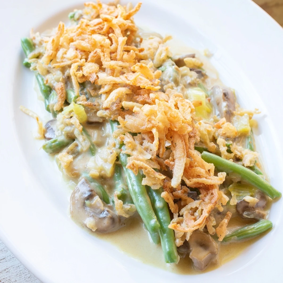 Steamy Green Bean Casserole with creamy sauce and crispy onions, ready to serve as a holiday side.