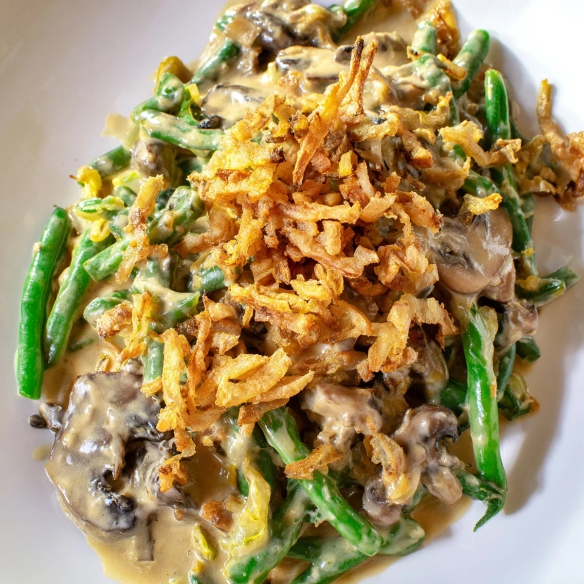 Steam rises from a freshly baked Green Bean Casserole with Crispy Onions, revealing bubbly edges and a generous layer of crisp, golden-fried onions.