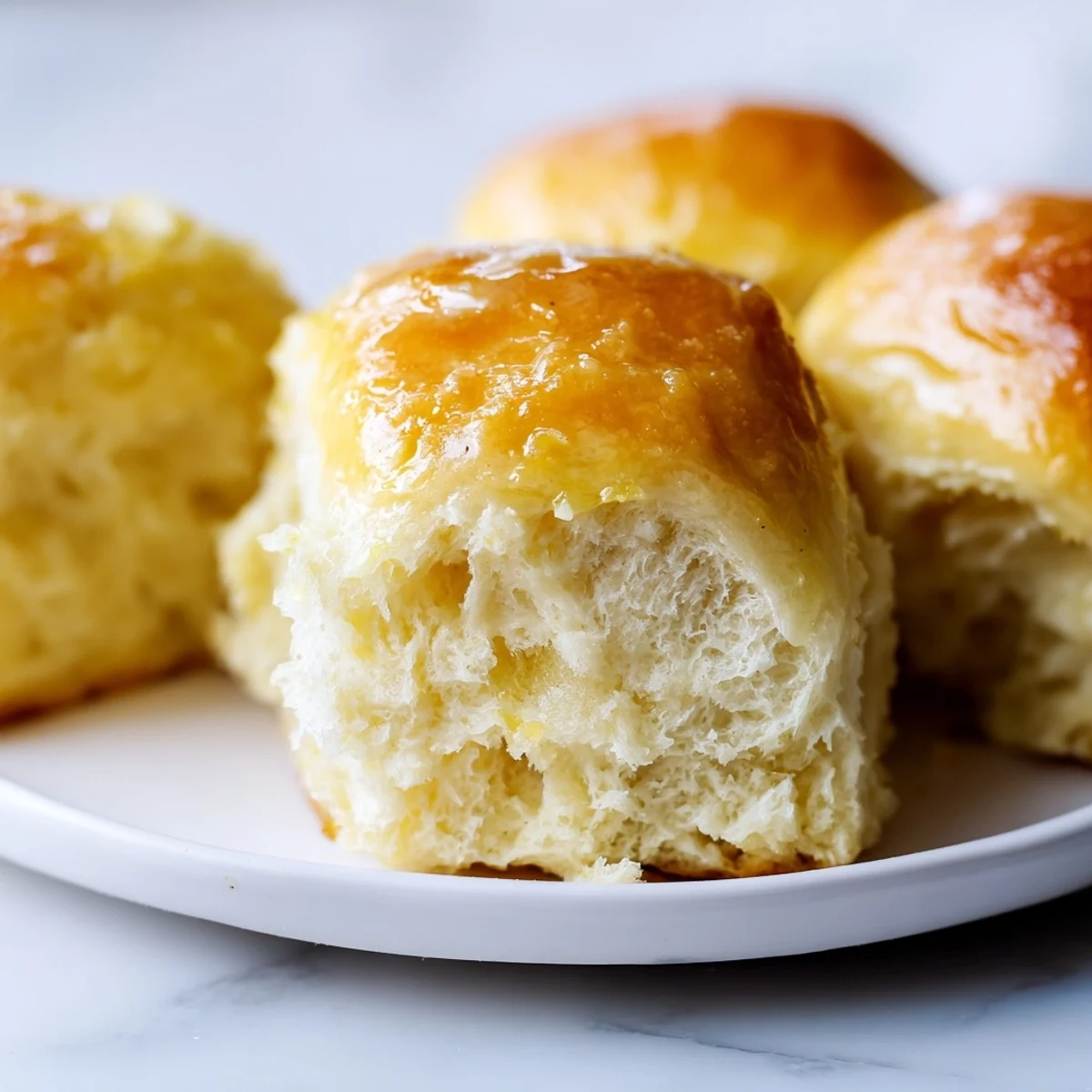 A close-up of soft, pillowy Best Vegan Dinner Rolls arranged in a baking dish, perfect alongside a hearty soup or salad.