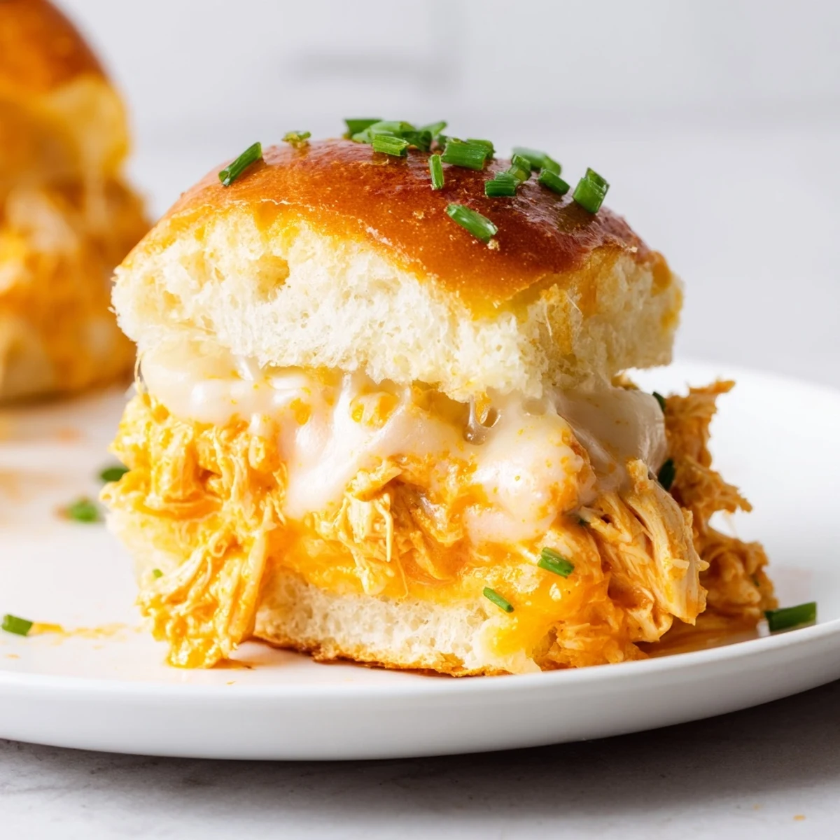 Cheesy Buffalo Chicken Pizza Dip Sliders arranged on a platter, perfect for game day, with a spicy kick and a cool ranch dipping sauce.