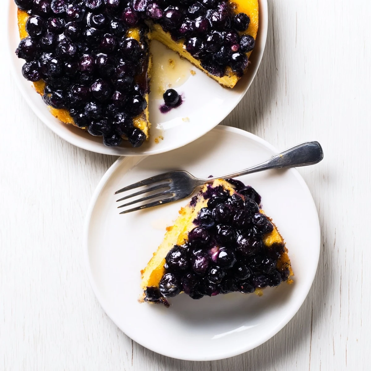 Moist blueberry upside down cake slice revealing juicy caramelized berries in every bite