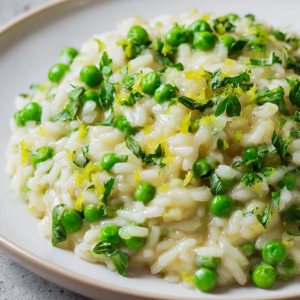 Close-up of vibrant spring pea risotto with bright peas folded into tender Arborio rice