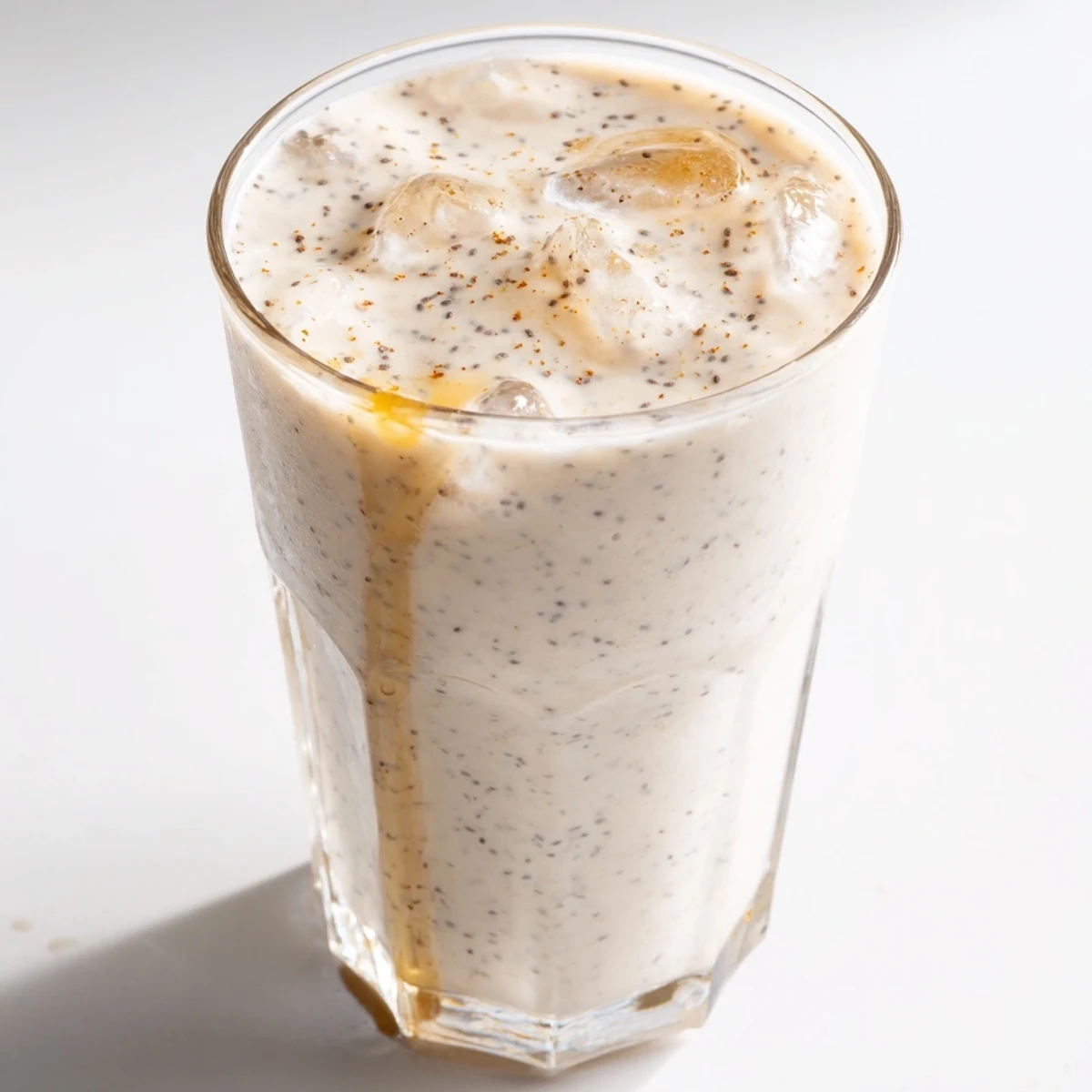 Creamy Greek yogurt banana smoothie topped with fresh banana slices in a glass