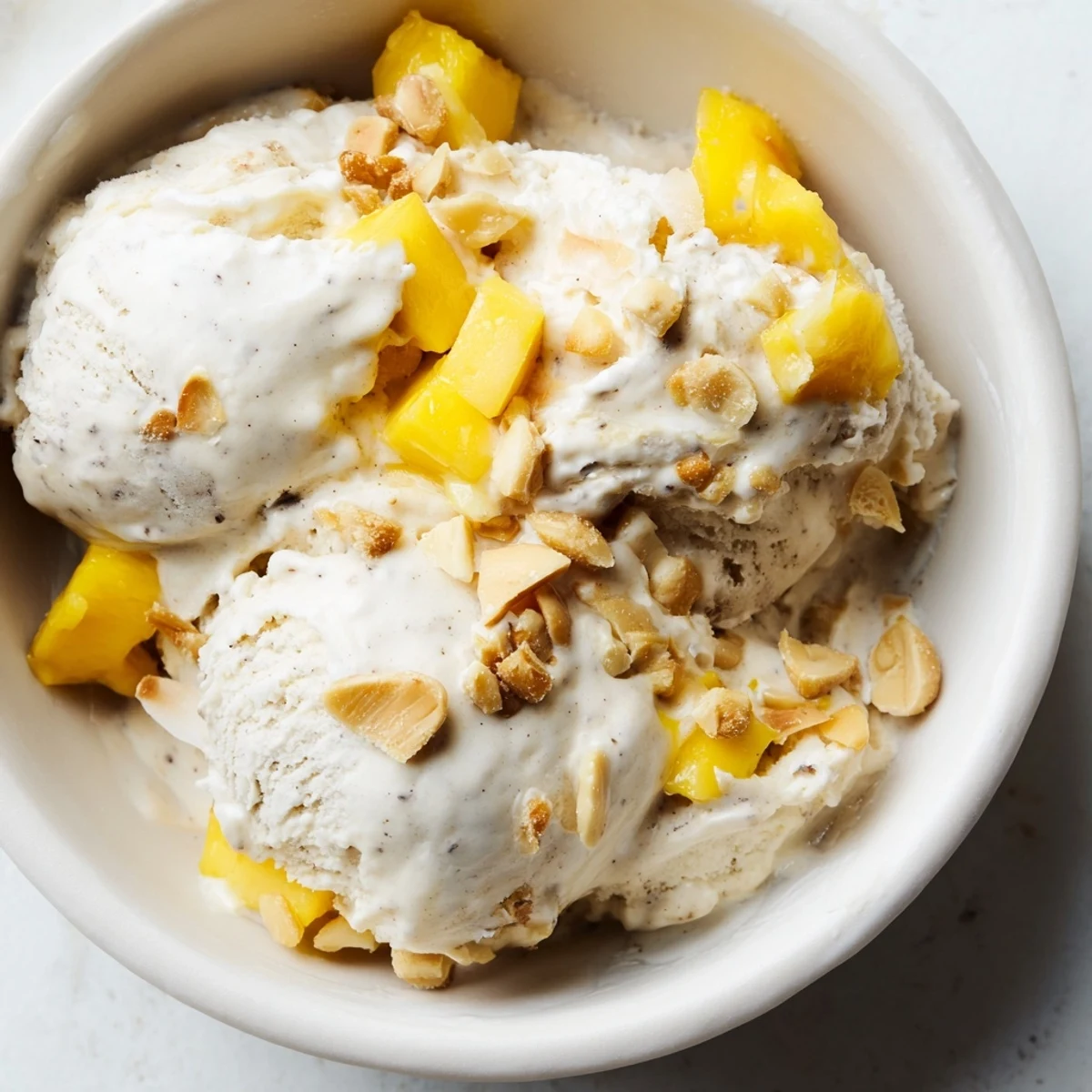 Vegan dairy-free Thai coconut milk ice cream served in a chilled bowl with chopped roasted peanuts