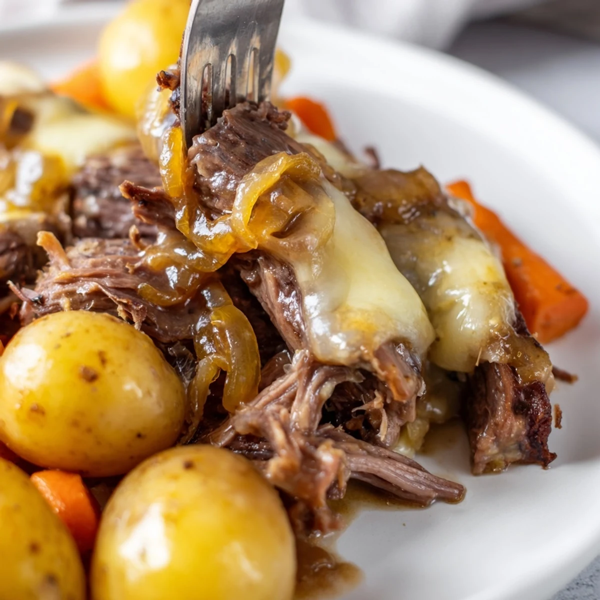 Fork-tender beef chuck roast braised with sweet onions in a savory dark French onion sauce