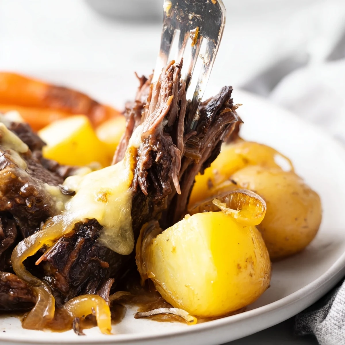 Golden-brown French onion pot roast served with melted Gruyère and tender roasted vegetables
