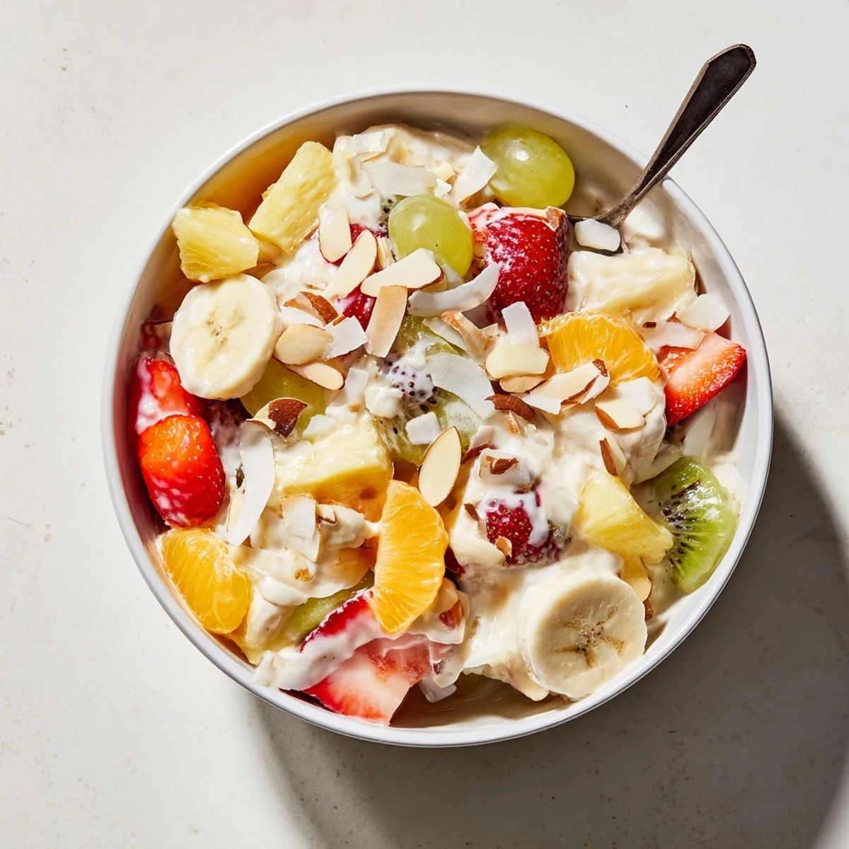 Refreshing creamy fruit salad with mixed fresh berries coated in vanilla Greek yogurt cream sauce