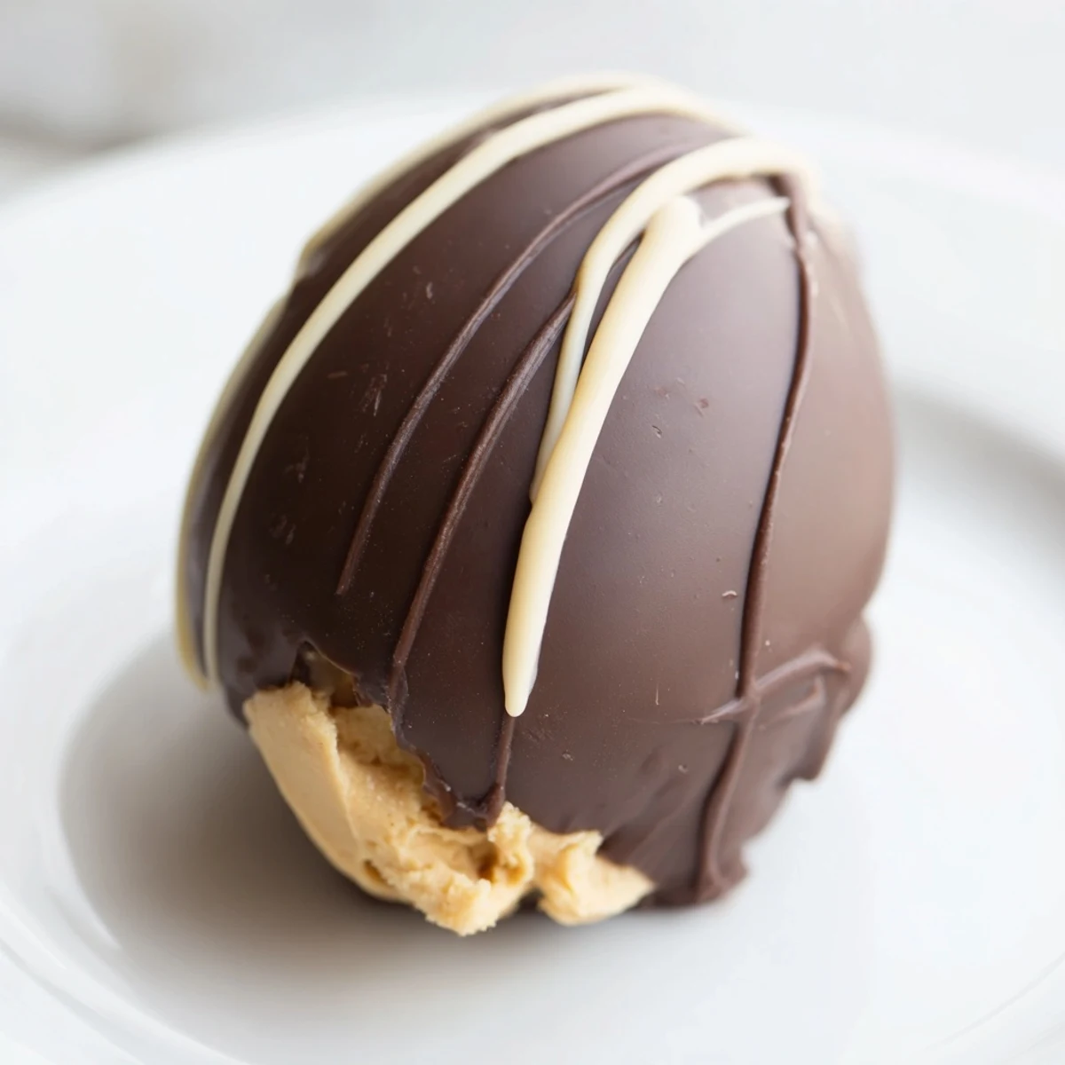 Handmade peanut butter Easter eggs dipped in glossy dark chocolate with colorful sprinkle decorations