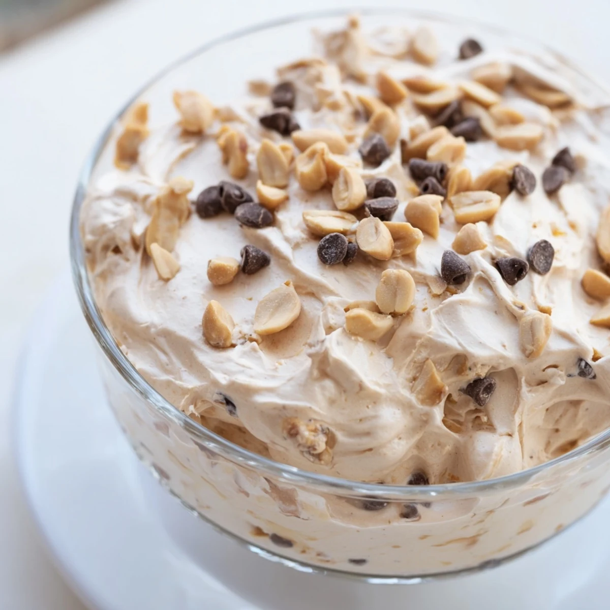 Velvety peanut butter and Cool Whip mousse served chilled with a crunchy topping of peanuts and chocolate sprinkles