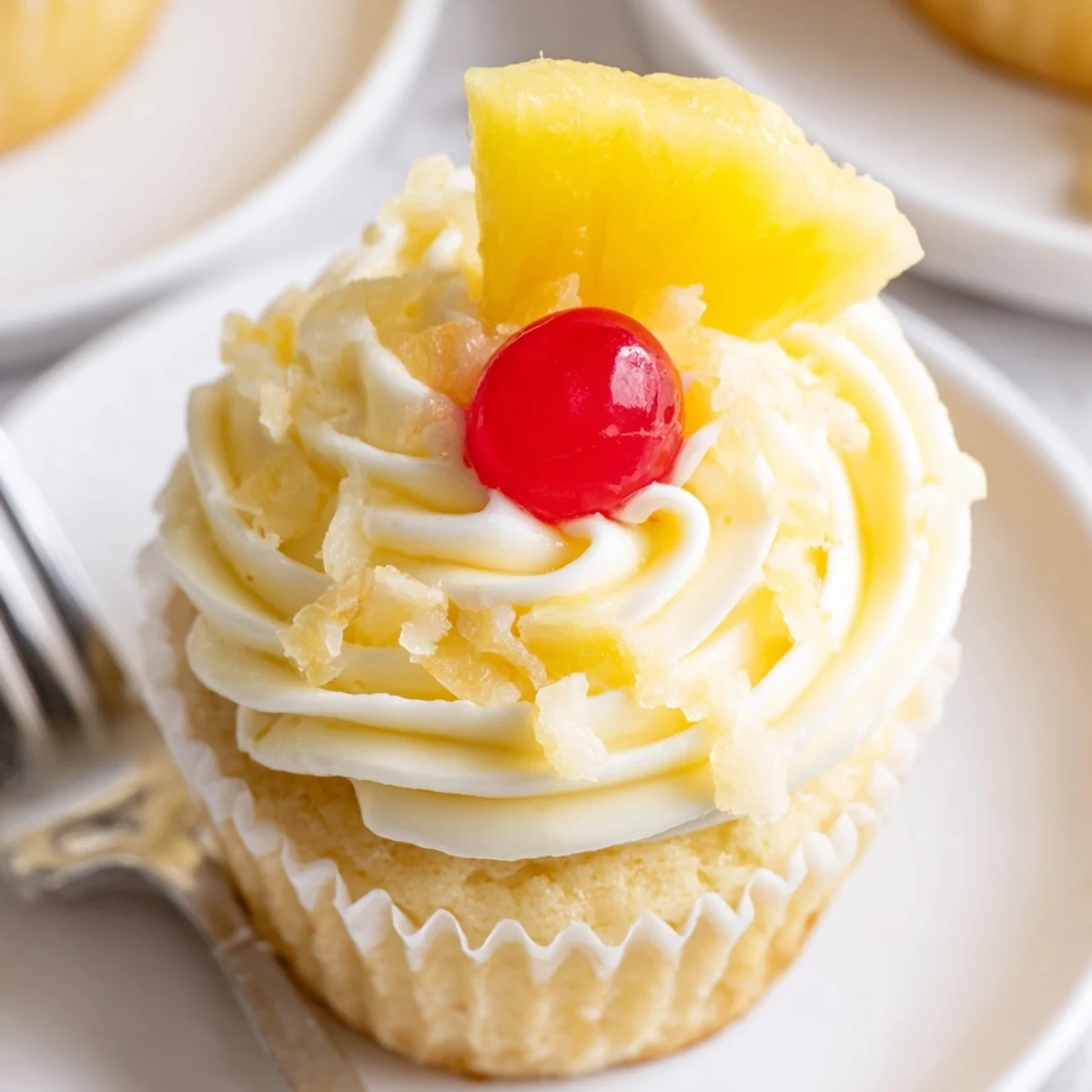 Dole Whip Cupcakes Recipe: fluffy pineapple cupcakes topped with creamy yellow frosting
