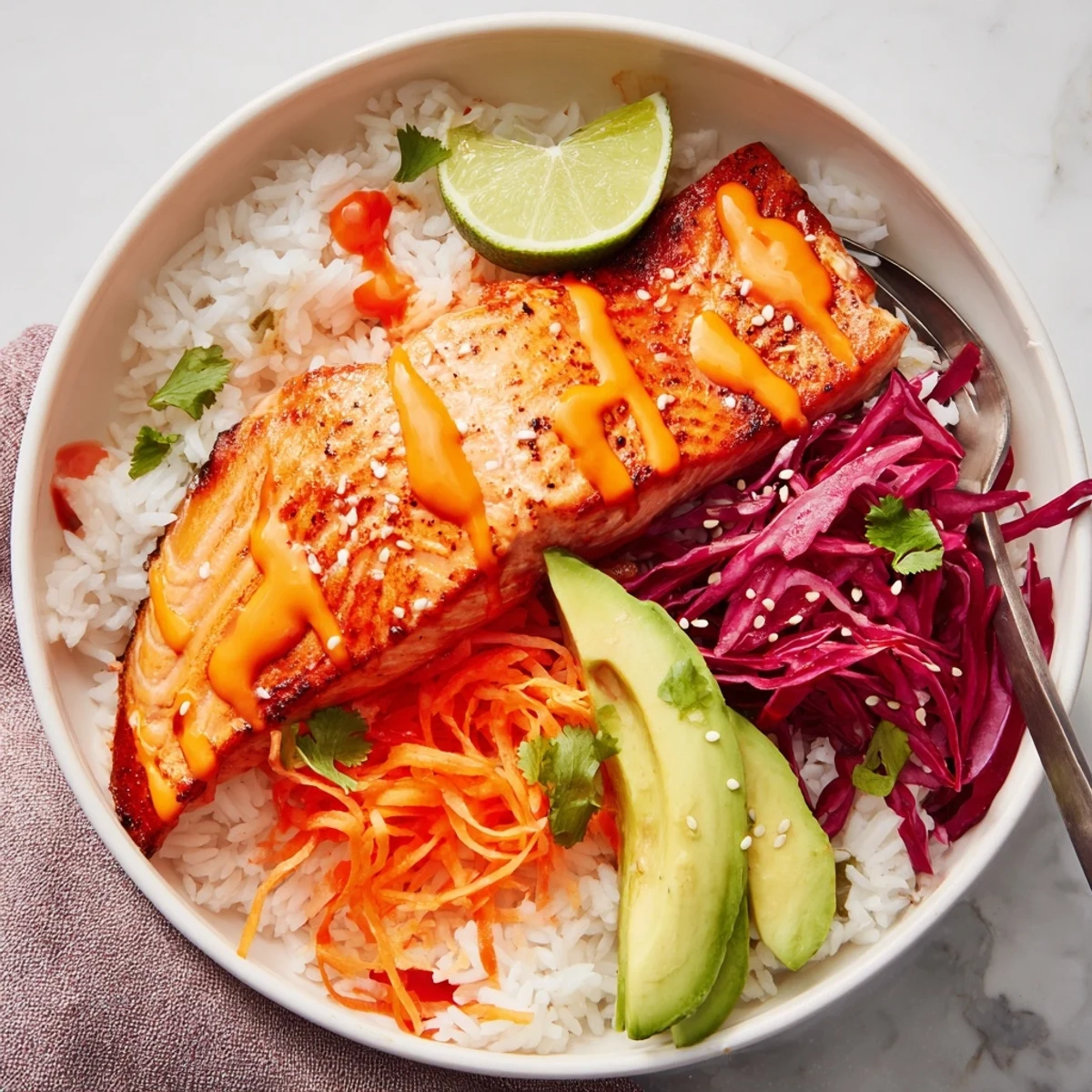 Bang Bang Salmon Bowls with roasted salmon, creamy spicy sauce, avocado slices
