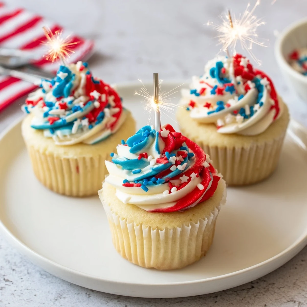 Vanilla-scented Patriotic Firework Cupcakes with velvety frosting and festive sprinkles