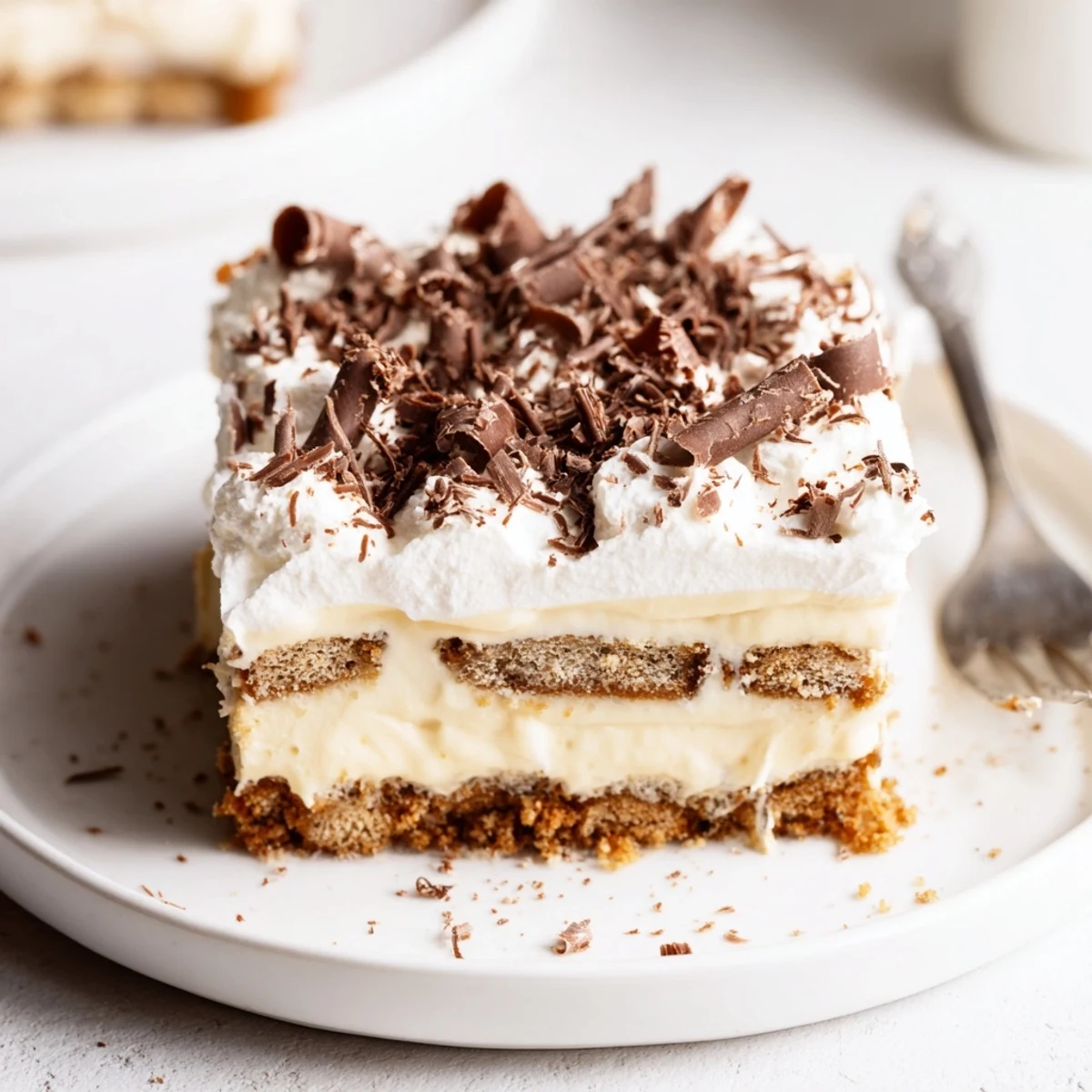 No Bake Layered Dessert chilled in a glass dish with chocolate shavings