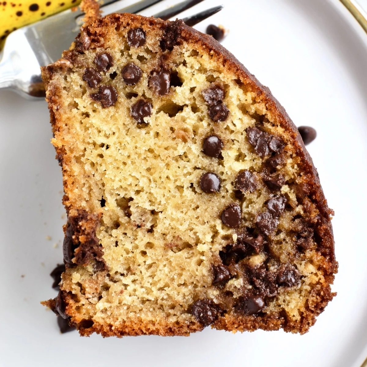 Moist Banana Chocolate Chip Cake Recipe sliced, served with vanilla ice cream