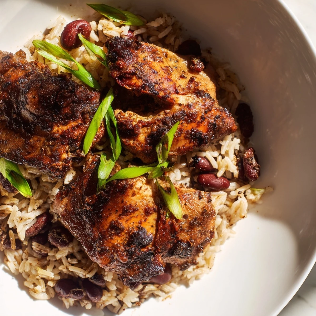 Spicy jerk-marinated chicken thighs atop fragrant coconut rice with kidney beans