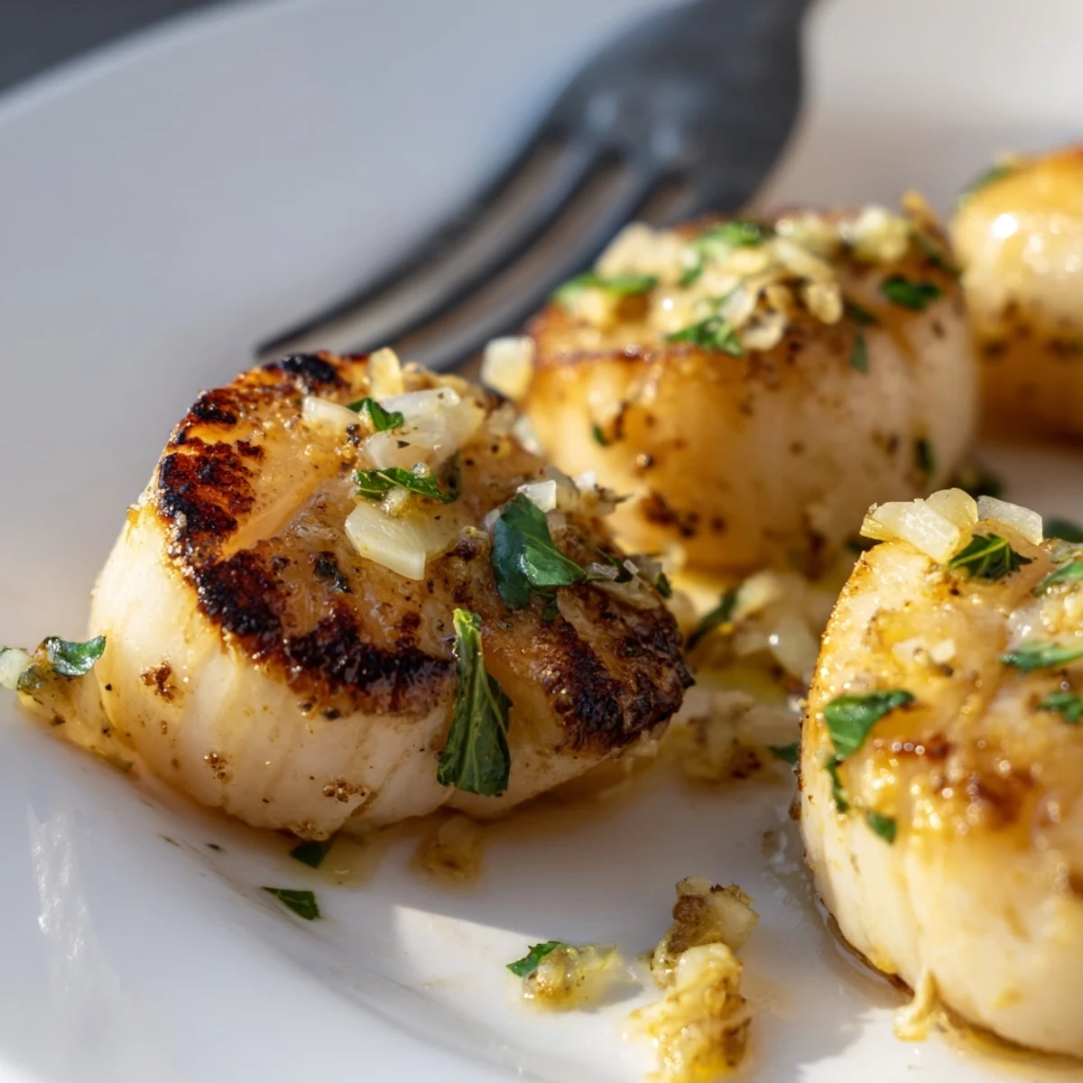 Perfectly seared scallops recipe with a golden crust and herb marinade glistening under natural lighting for an elegant seafood dinner