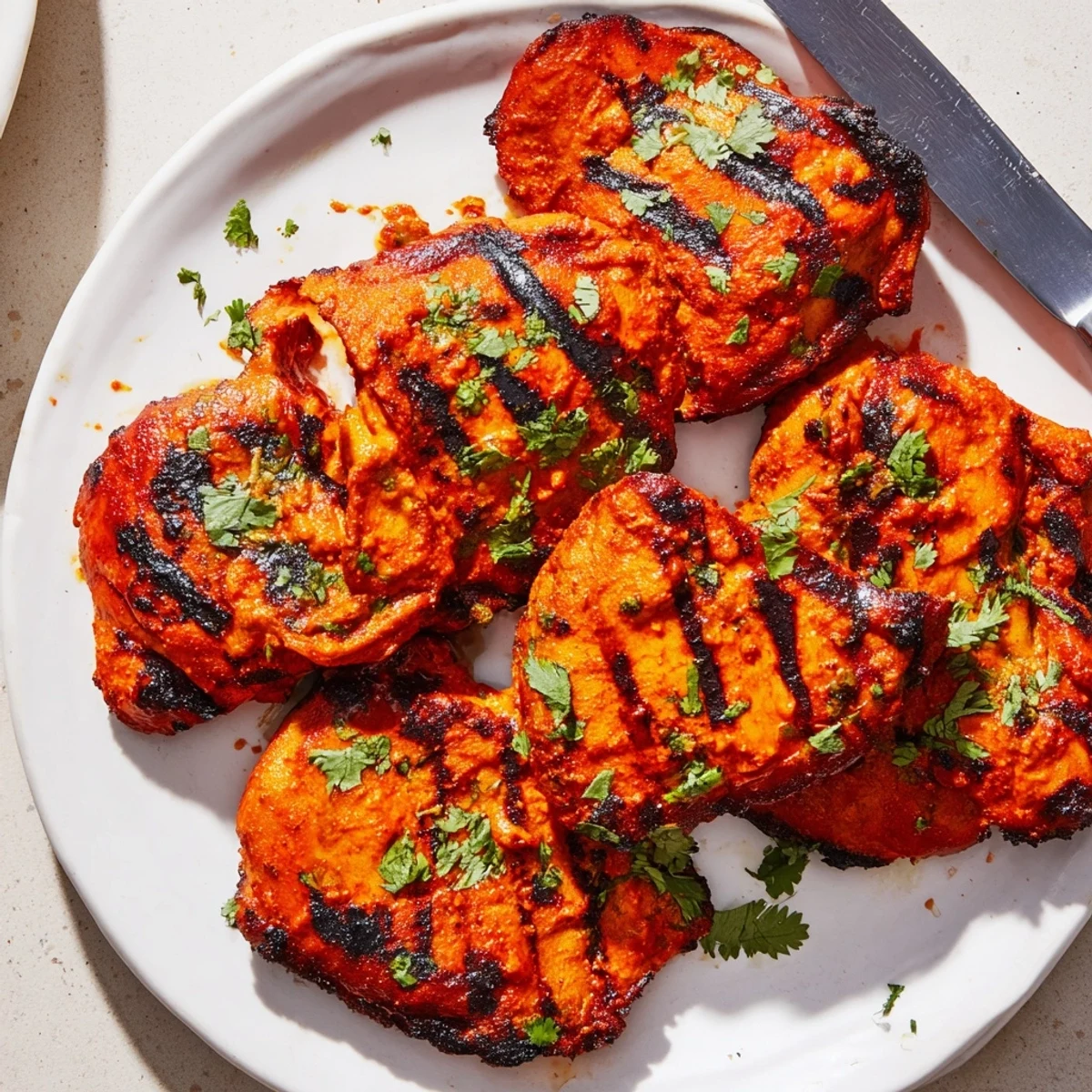 Spicy yogurt-marinated Tandoori Chicken pieces roasted to golden perfection on a wire rack