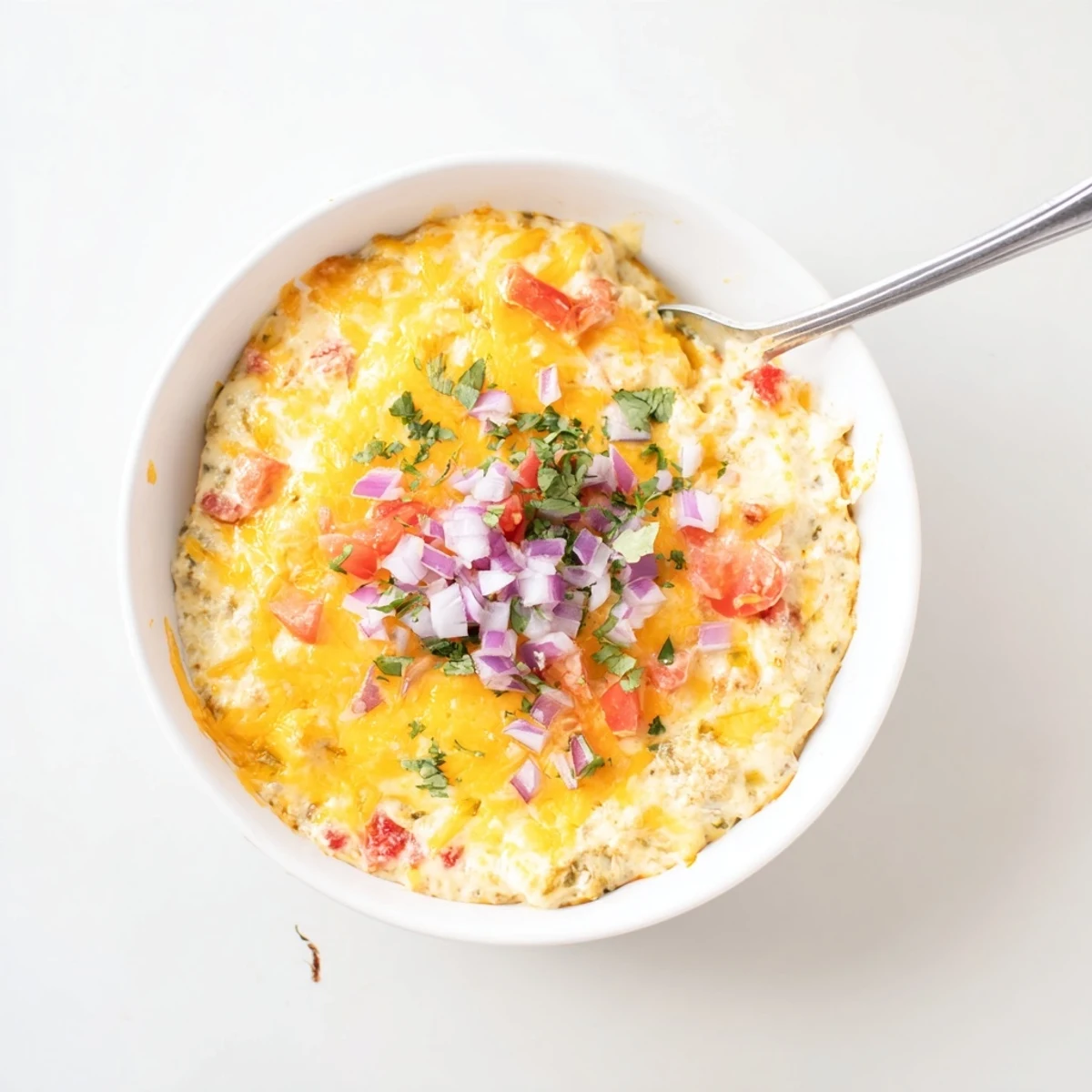 Creamy green chile queso dip with melted cheese and roasted green chiles in a serving bowl