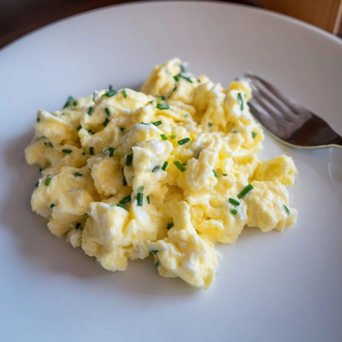 Plate of Cottage Cheese Scrambled Eggs With Chives, soft curds and herbal brightness