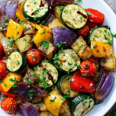 Freshly roasted Italian Roasted Vegetables with balsamic glaze, served warm as a colorful side dish.